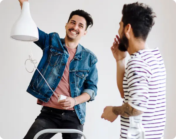 Man showing other man a vase