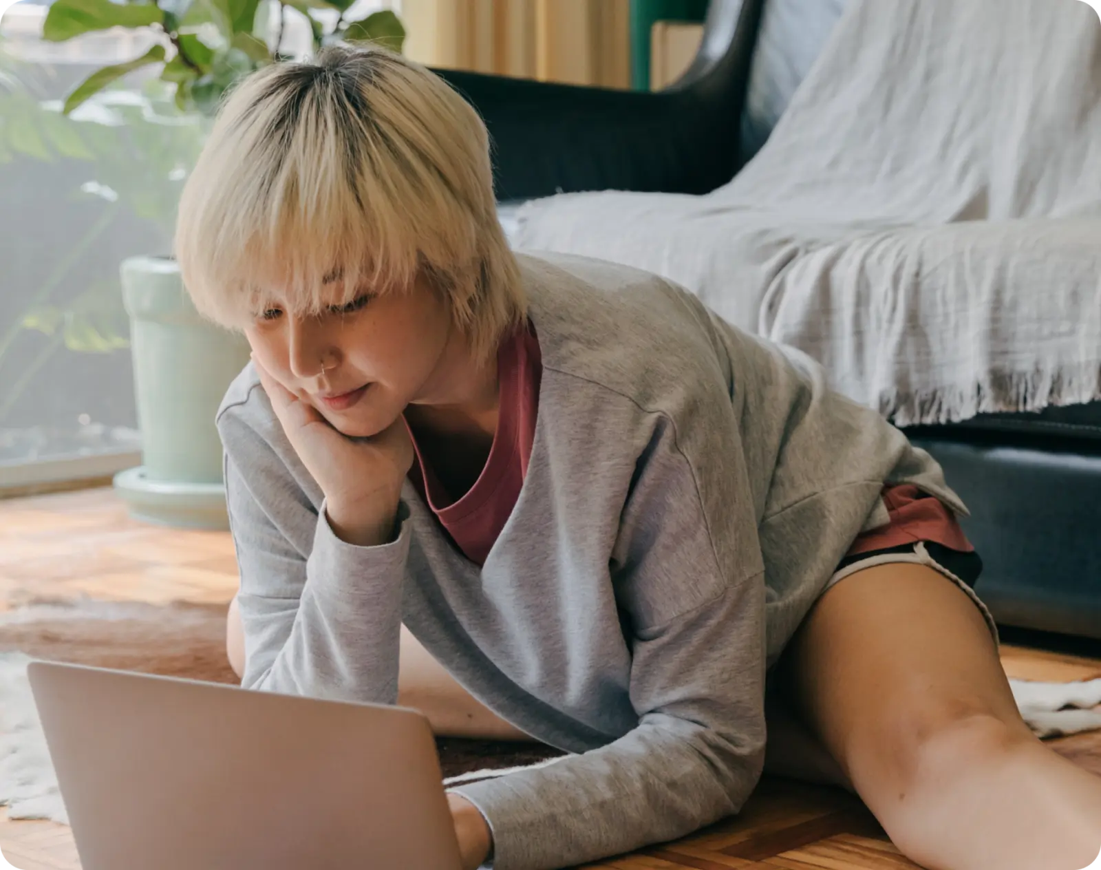 woman on floor typing into her computer